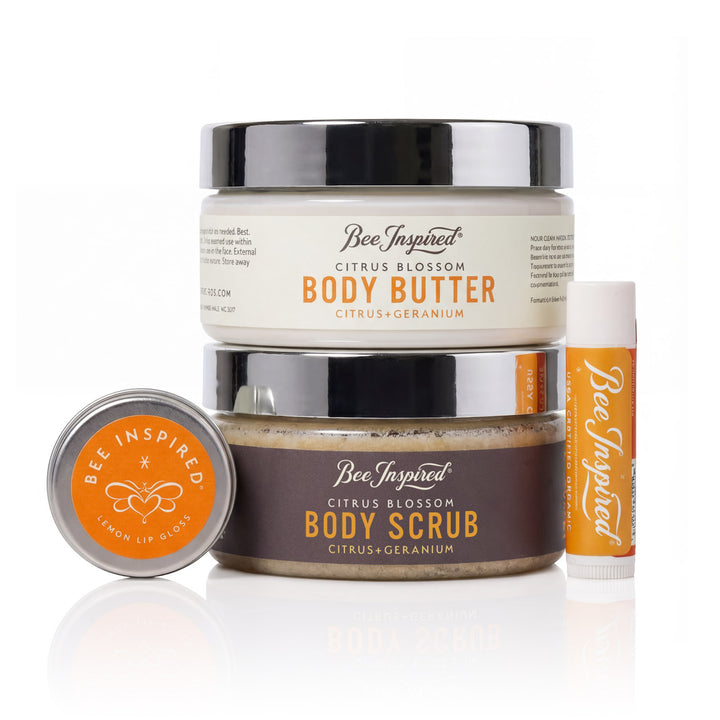 Bee Inspired body butter, scrub, and lip balm set on a white background