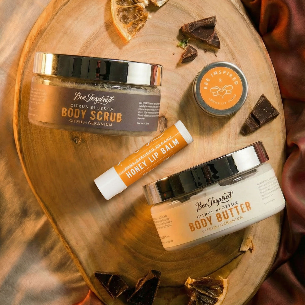 Collection of Bee Inspired skincare products on a wooden board with natural elements.