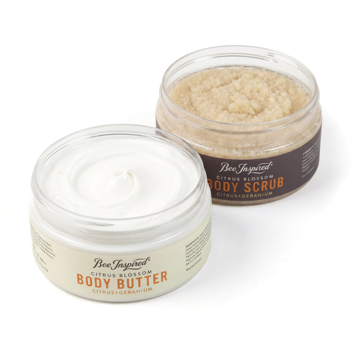 Two jars of Bee Inspired body butter and scrub on a white background