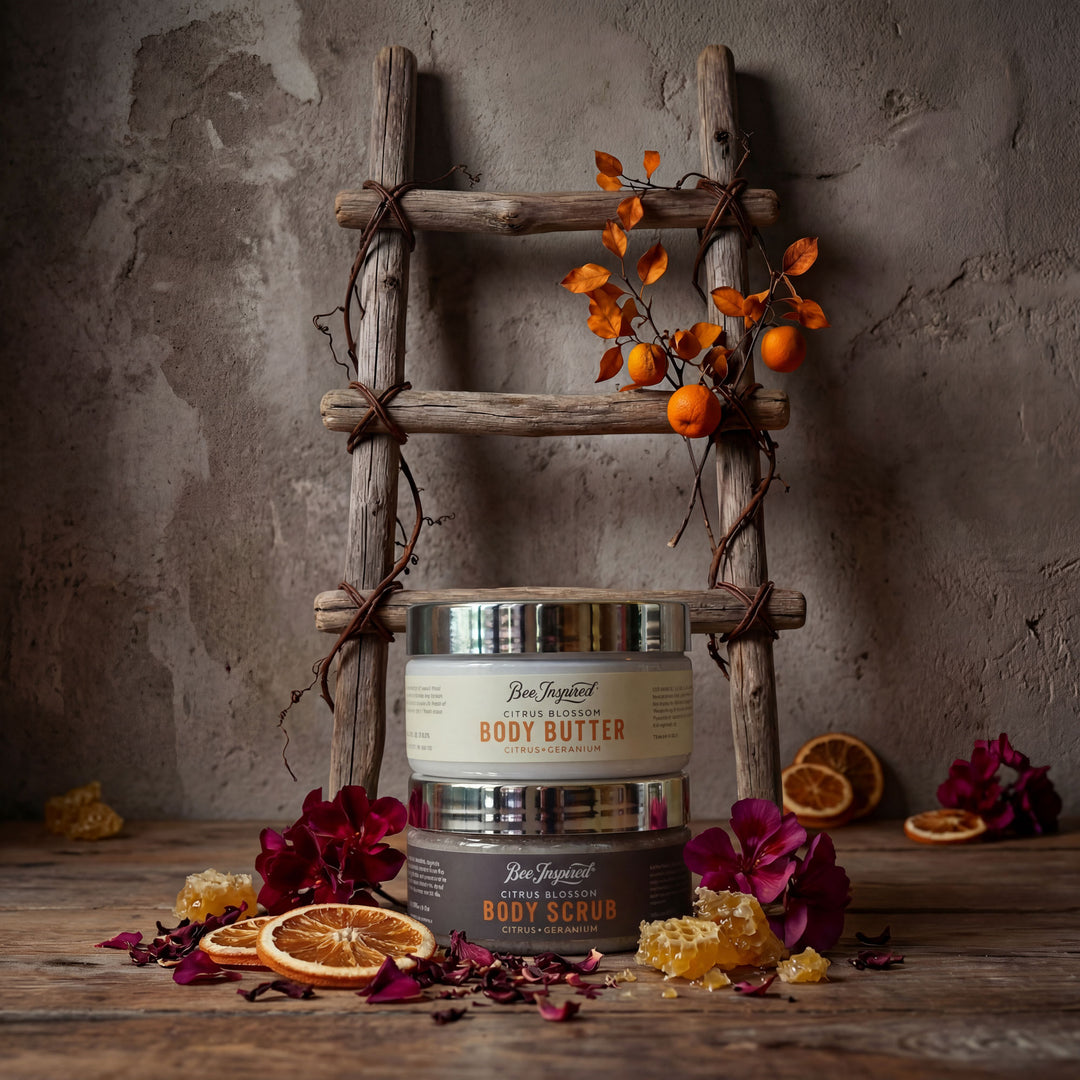 Body scrub and body butter containers on a wooden surface with decorative elements.