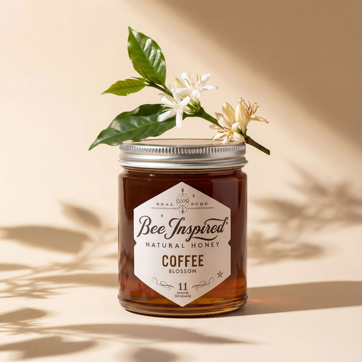 Jar of 'Bee Inspired' natural honey with a coffee blossom on a beige background