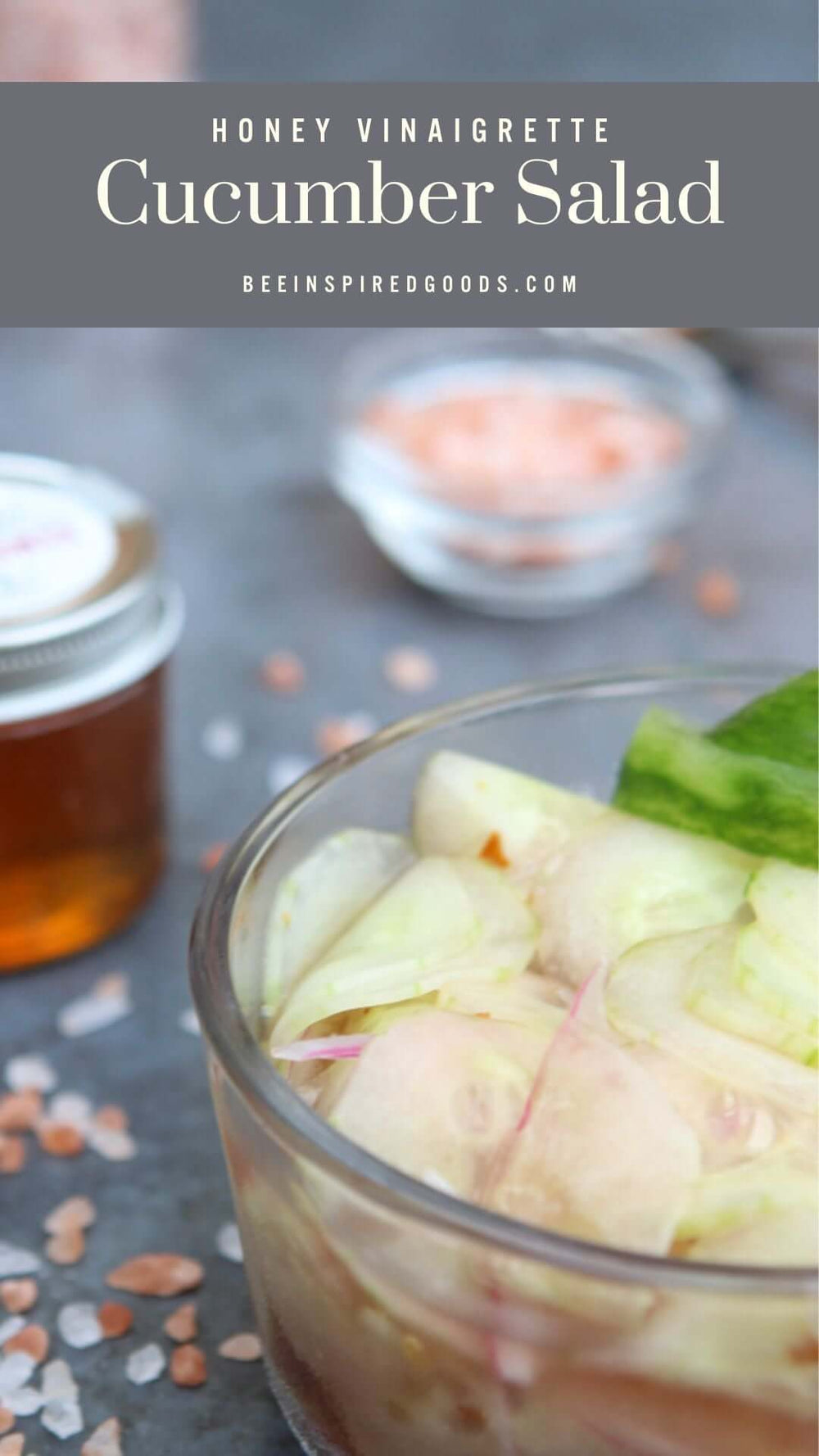 "Honey Vinaigrette Cucumber Salad beeinspiredgoods.com" a bowl of sliced vegetables next to a jar of honey