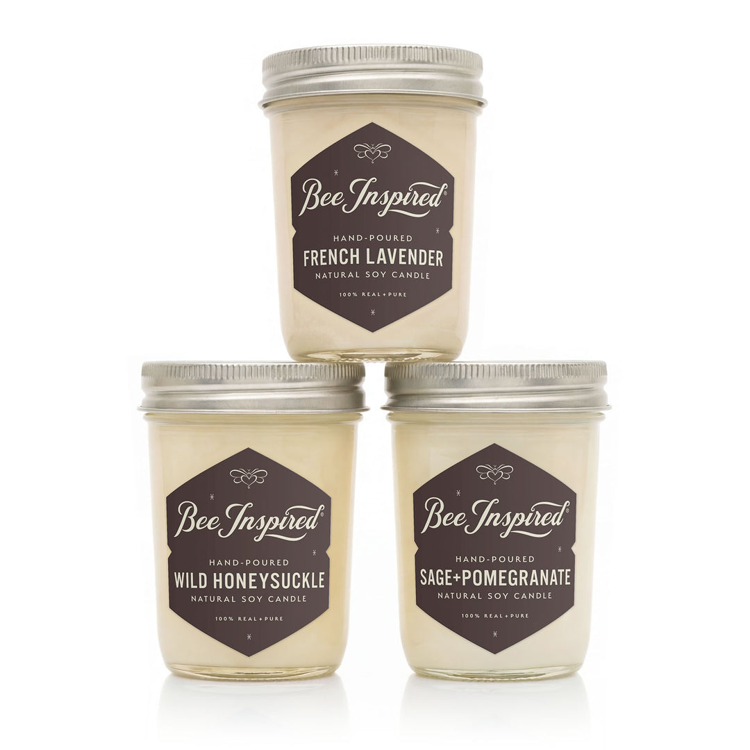 Three 'Bee Inspired' candles with different scents on a white background