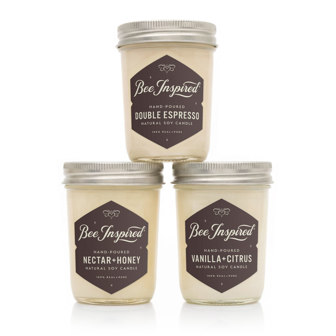 Three 'Bee Inspired' candles with different scents on a white background