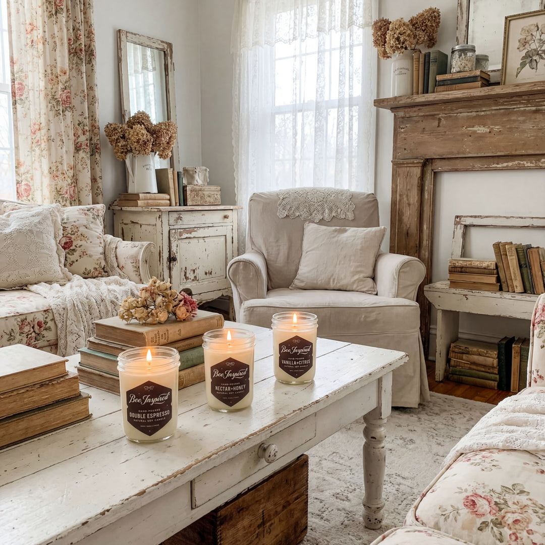 Cozy living room with candles on a wooden table, floral curtains, and a fake fireplace.