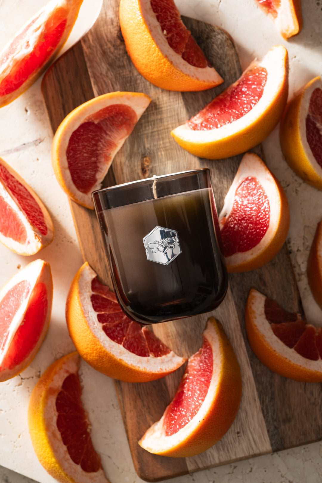 Ruby Red Grapefruit luxe candle flat lay on grapefruit slices 