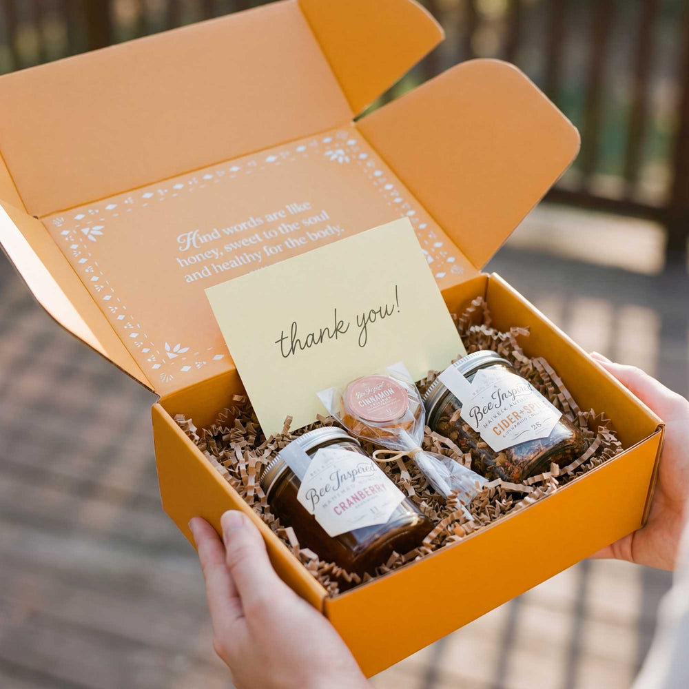 Orange gift box with 'thank you!' card and Bee & Vine products.