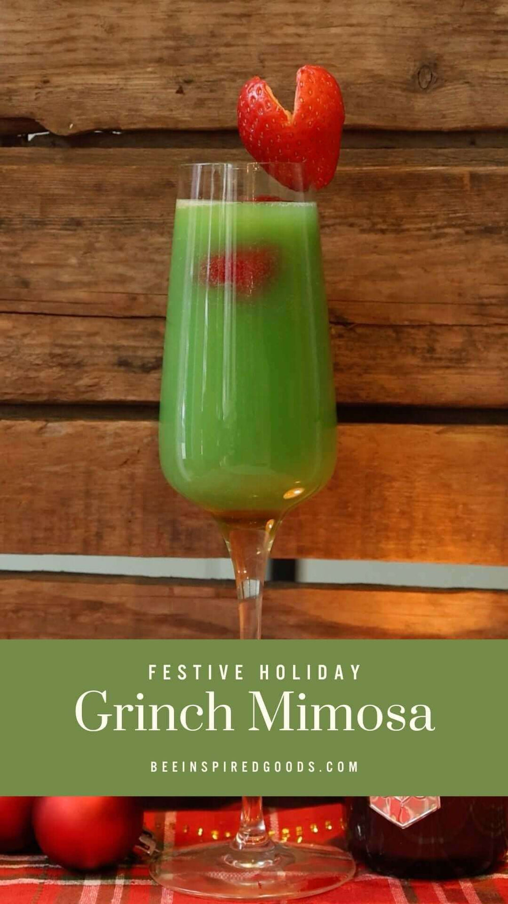 "Festive Holiday Grinch Mimosa beeinspiredgoods.com" with a green cocktail garnished with a strawberry 