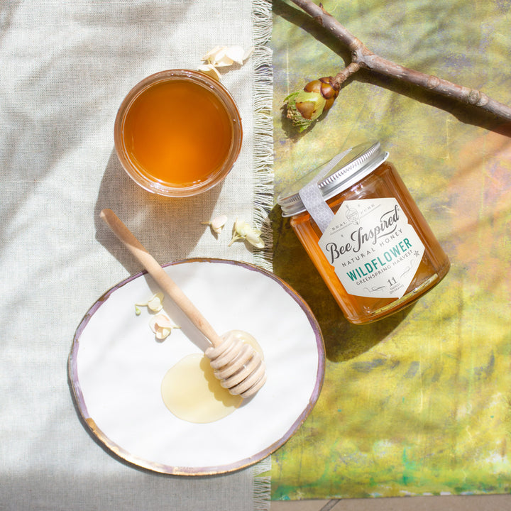 greenspring wildflower honey from bee inspired honey retail store in owings mills with honey dipper on blanket 