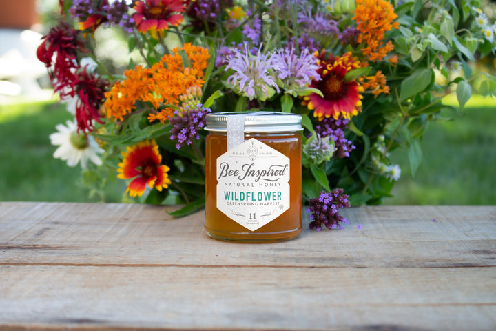 greenspring wildflower honey from bee inspired honey retail store in owings mills in front of flower bouquet 