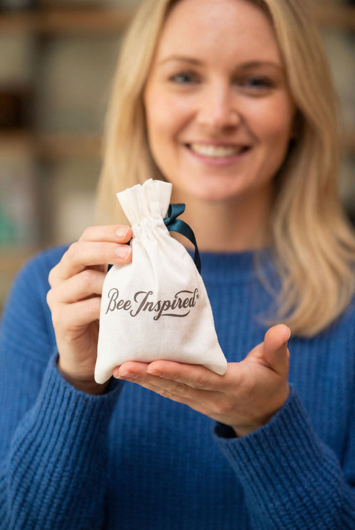 Woman holding a Bee Inspired party favor bag with a blurred background