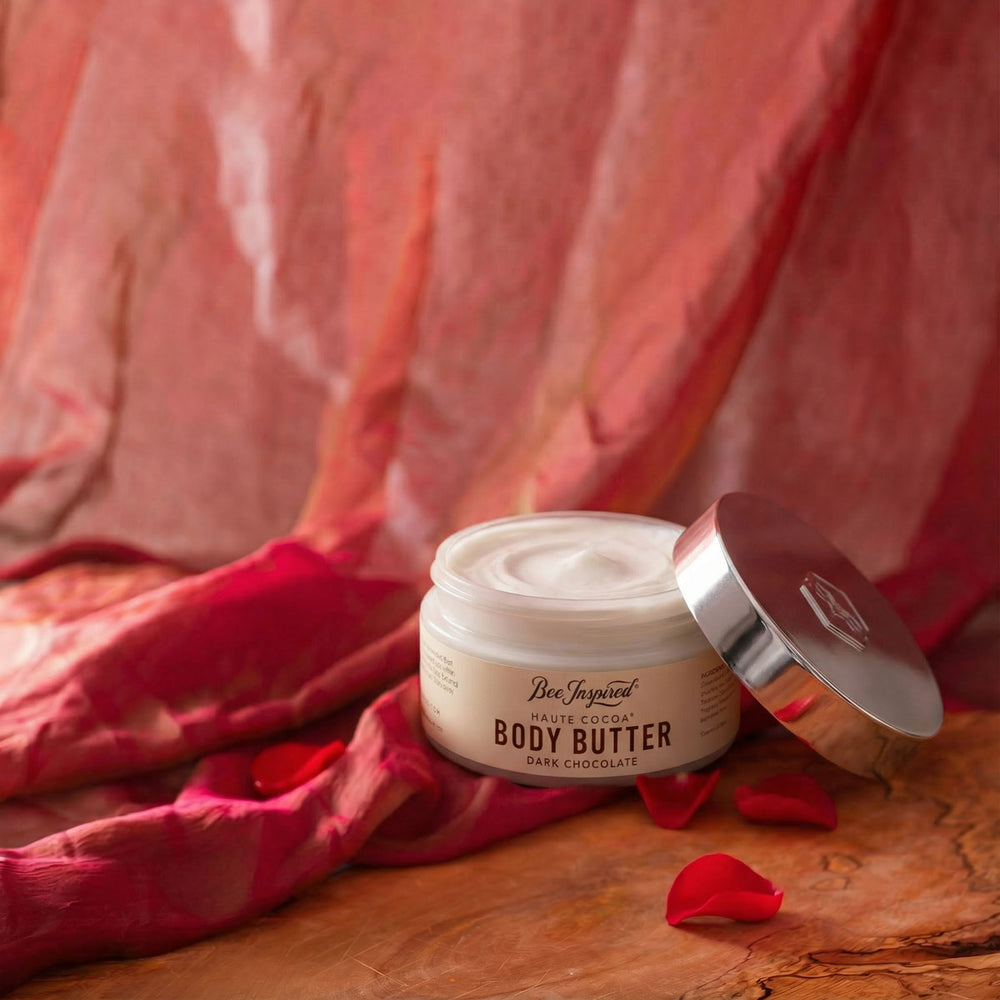 Jar of Haute Cocoa body butter with a red fabric background