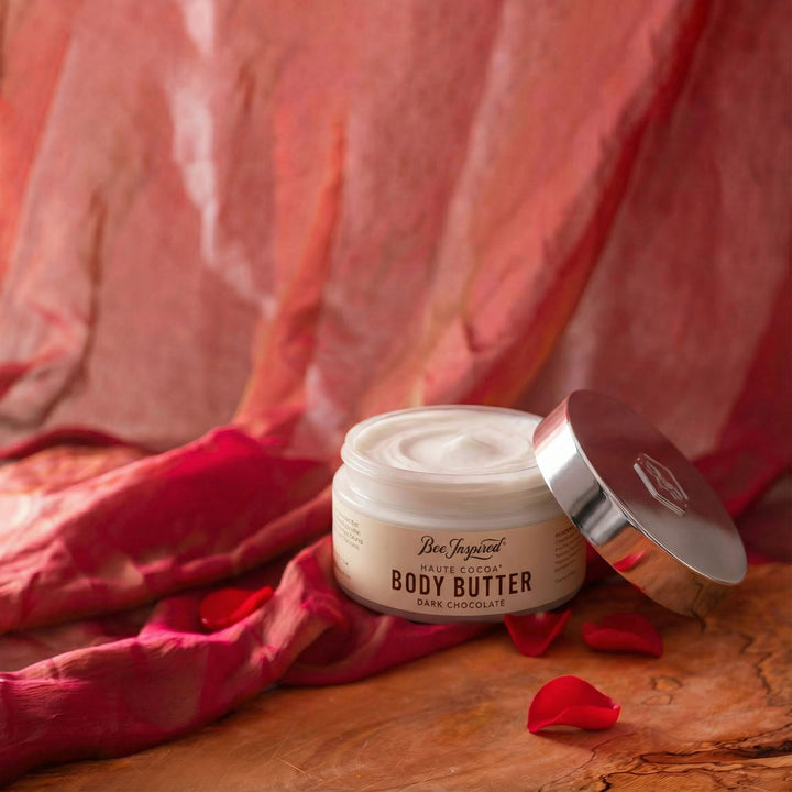 Jar of Haute Cocoa body butter with a red fabric background