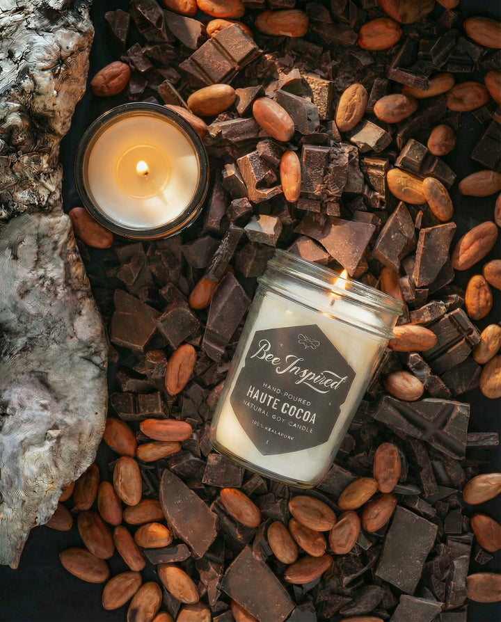 Bee Inspired candles surrounded by chocolate pieces and cocoa beans.
