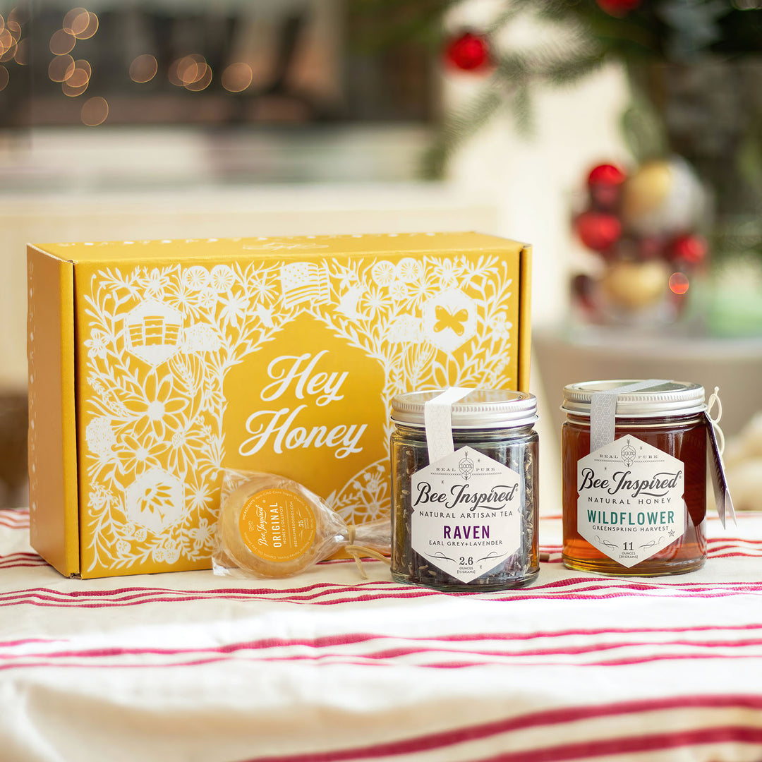 Hey Honey gift set with Raven tea, Wildflower honey, and honey lollipop from Bee Inspired Honey House in Owings Mills in front of holiday decorations 