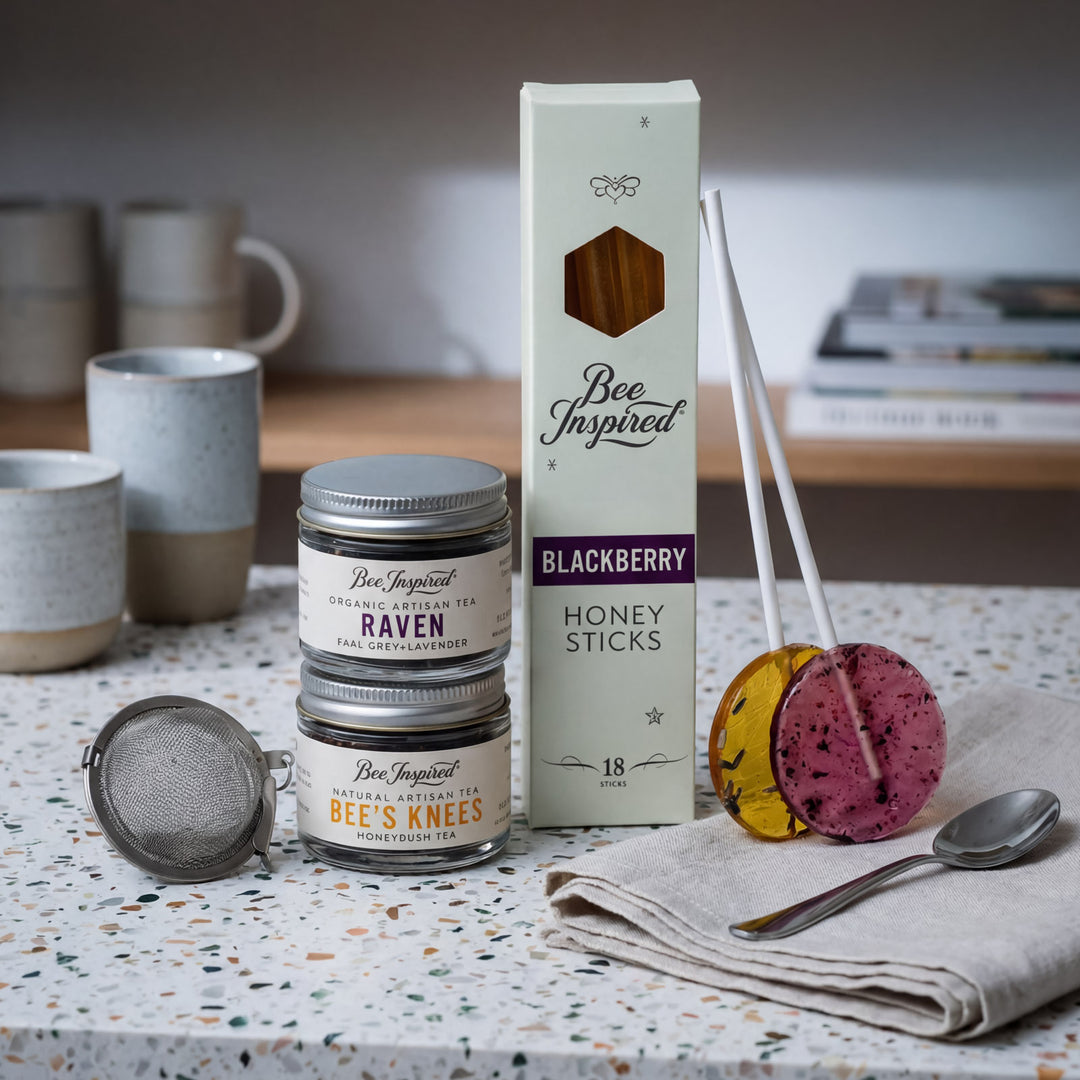Bee Inspired honey sticks and containers on a table with a blurred background