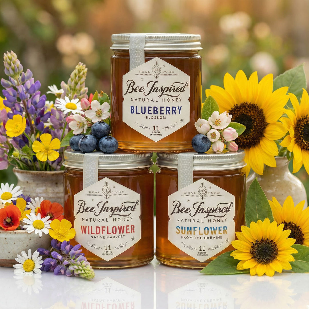 Jars of 'Bee Inspired' honey with floral decorations on a blurred natural background
