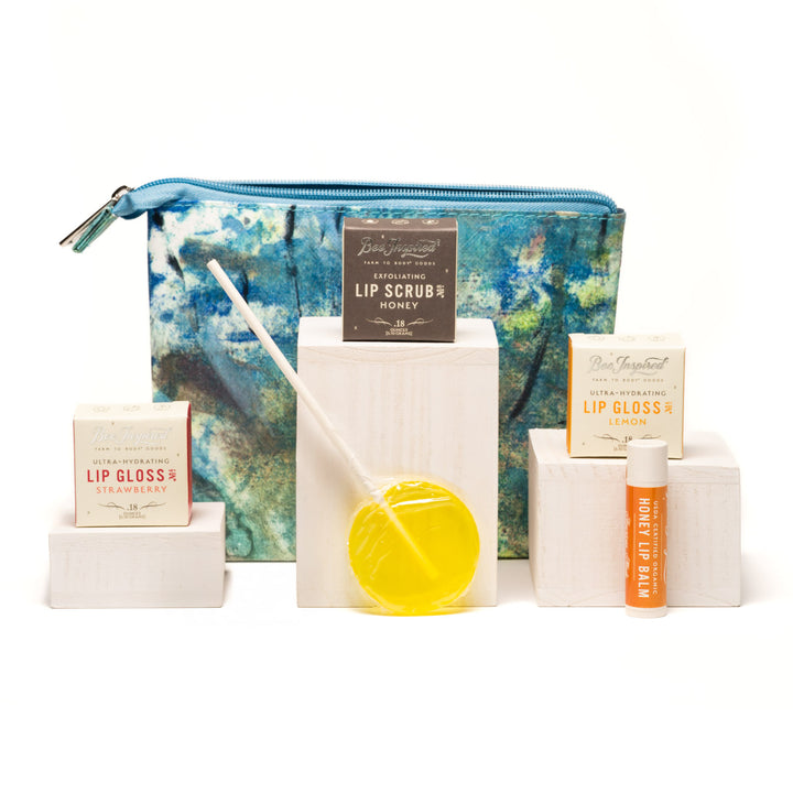 Collection of lip care products including lip gloss, scrub, and honey on a white background