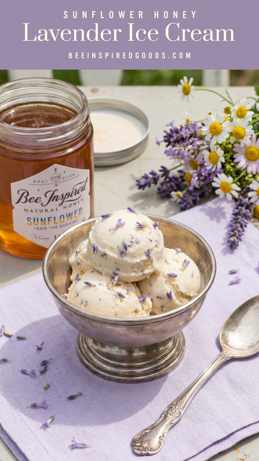 Bowl of lavender ice cream with a jar of sunflower honey on a table with flowers and a spoon.