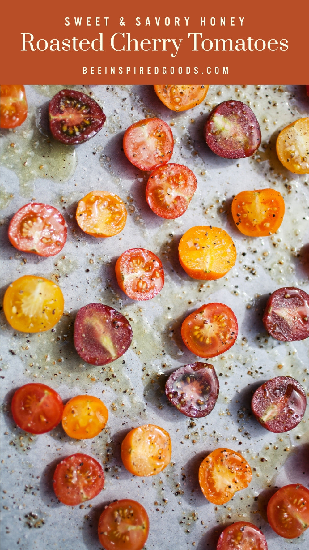 Honey roasted cherry tomatoes on a baking sheet with seasonings