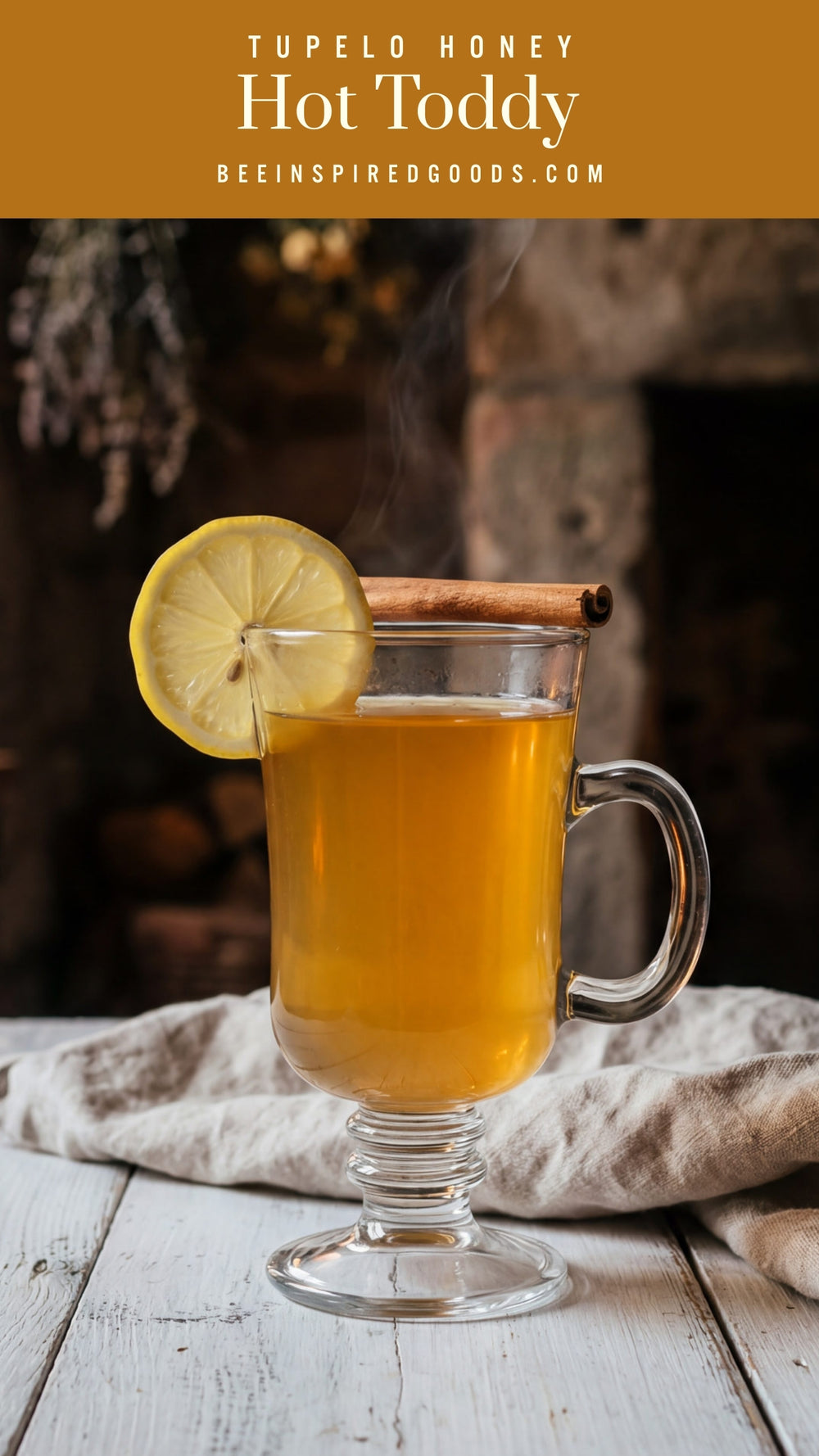 Hot toddy in a glass with lemon and cinnamon, featuring Tupelo Honey branding.