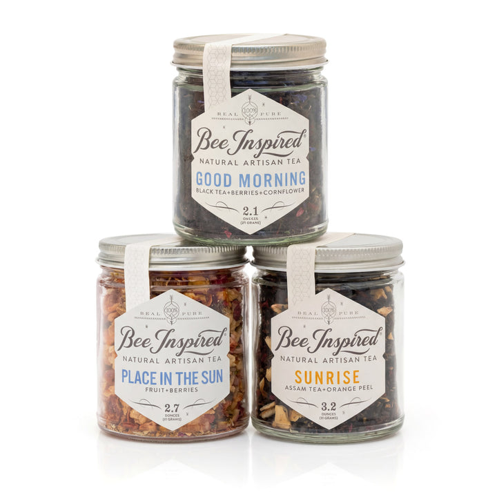 Three jars of 'Bee Inspired' natural artisan tea on a white background