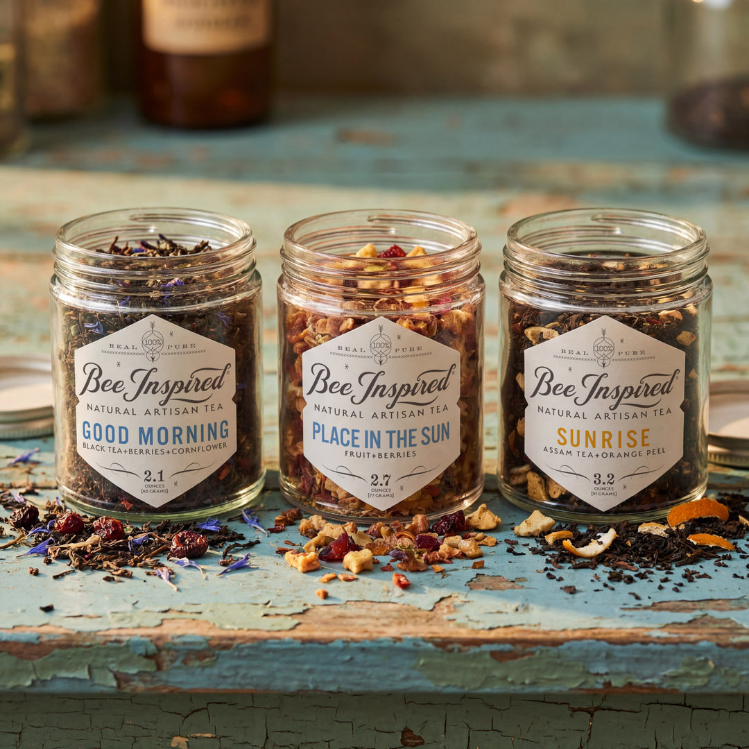 Three jars of 'Bee Inspired' tea on a rustic wooden surface