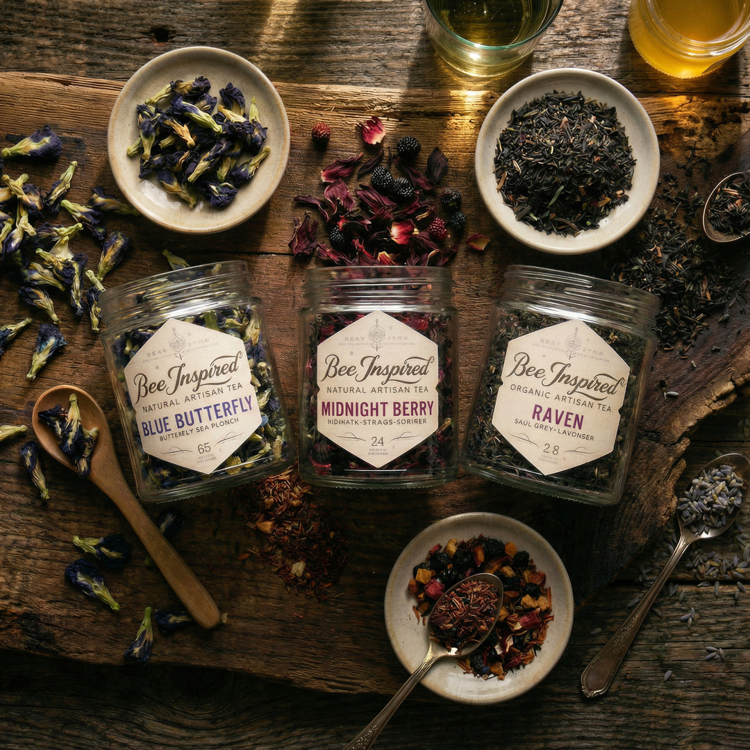 Bee Inspired mixologist's tea set on a wooden surface with loose leaf tea leaves and spoons and honey


