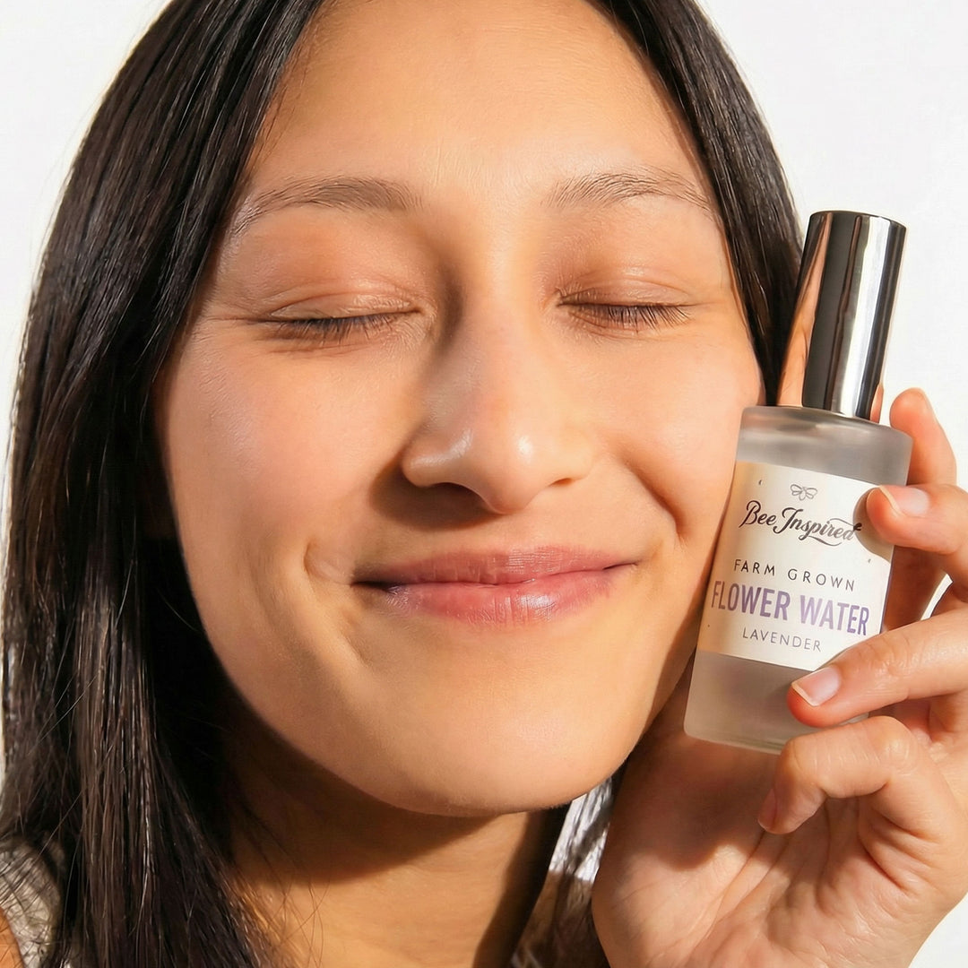 Woman holding a bottle of 'Bee & Harper' flower water with a blurred background