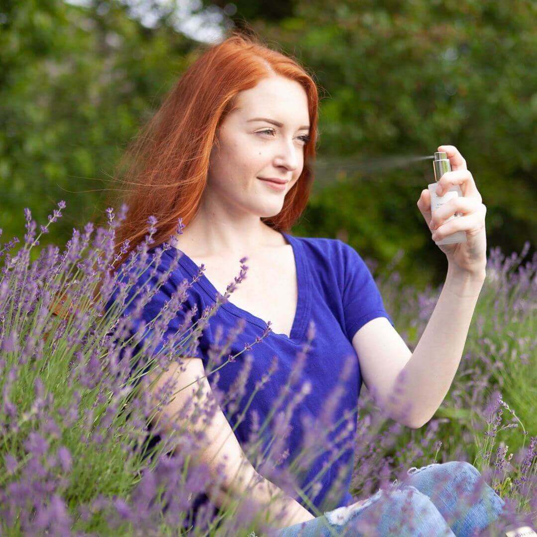 Spraying lavender flower water in a lavender field