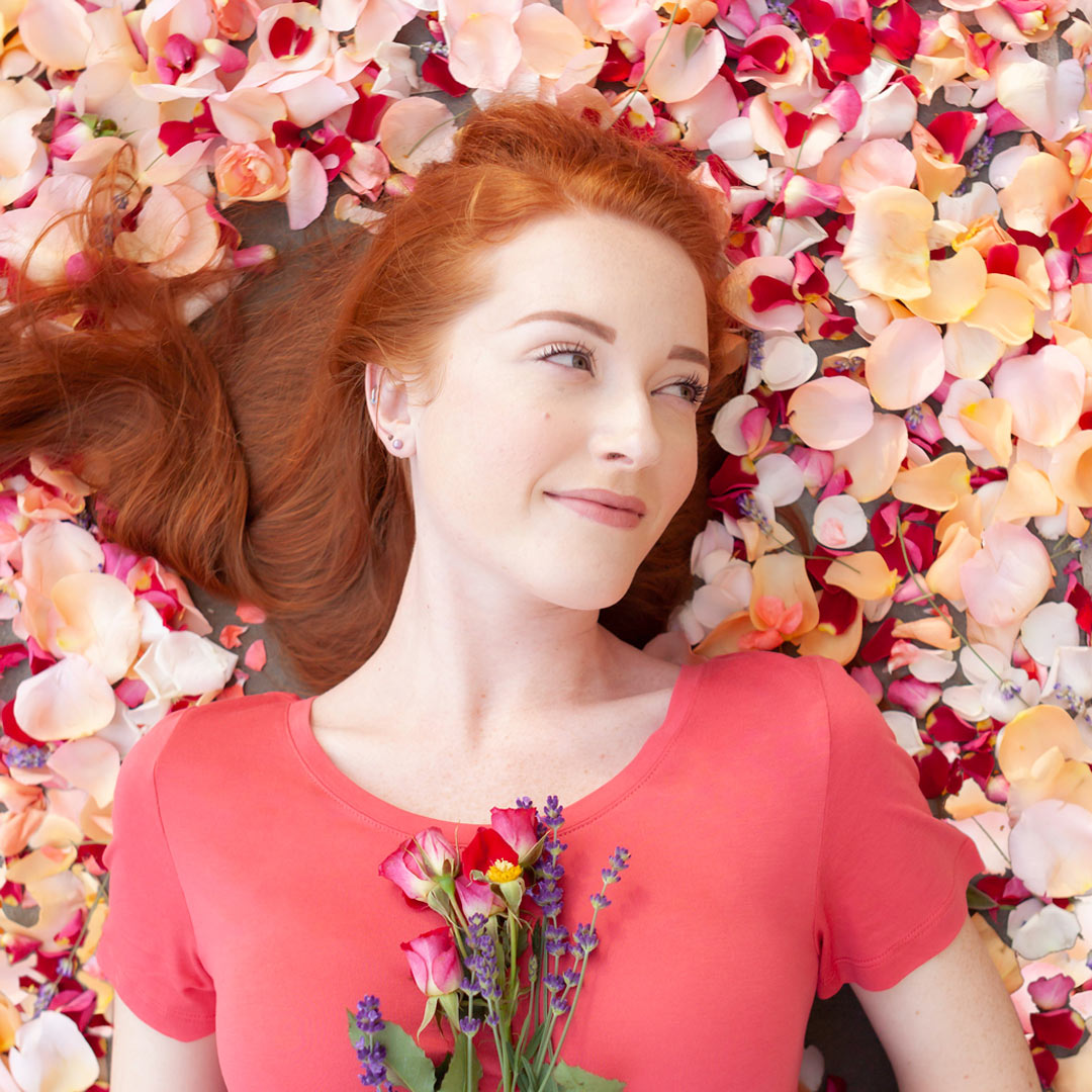 woman laying on rose petals