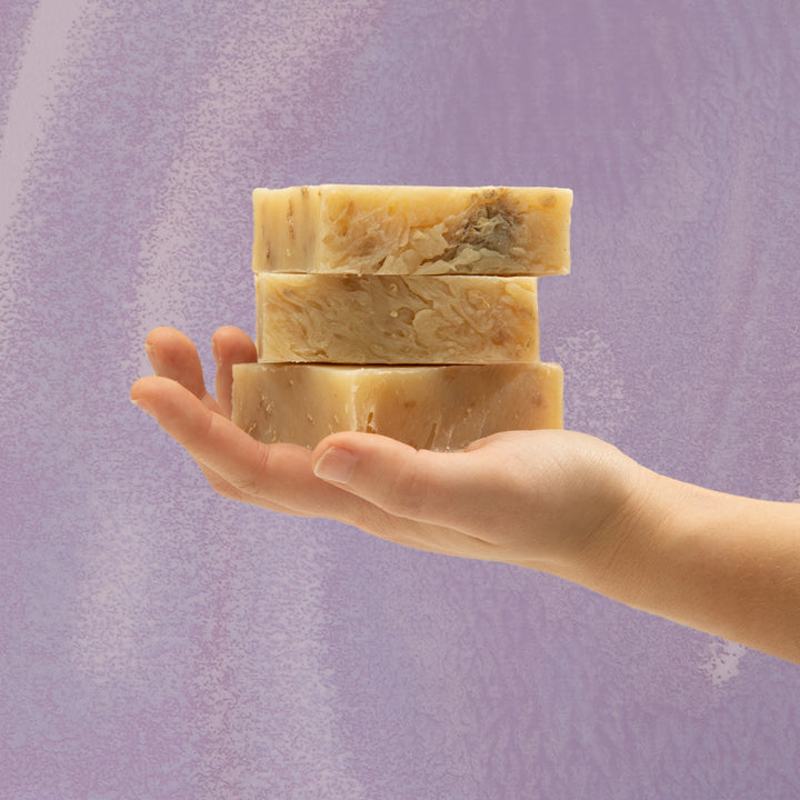 Person holding Oatmeal+Lavender soap stack 