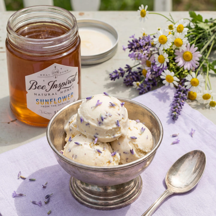 Bowl of lavender ice cream with a jar of honey and flowers on a table
