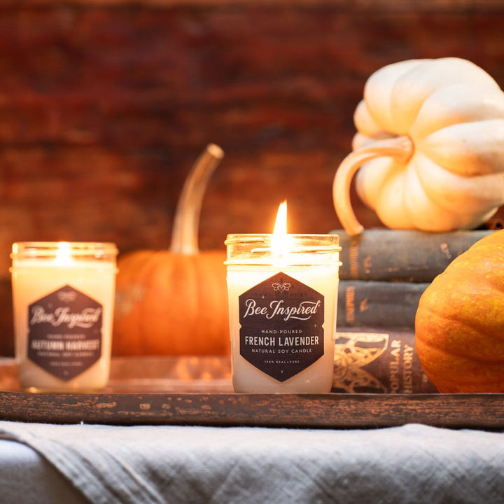 French lavender soy jelly jar candle with pumpkins and books in a library