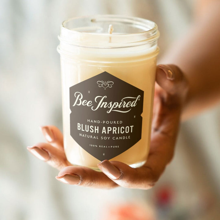 blush apricot jelly jar candle in hand