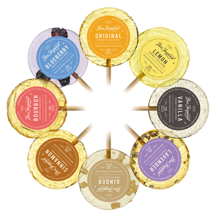 Assorted honey lollipops with labeled flavors on a white background