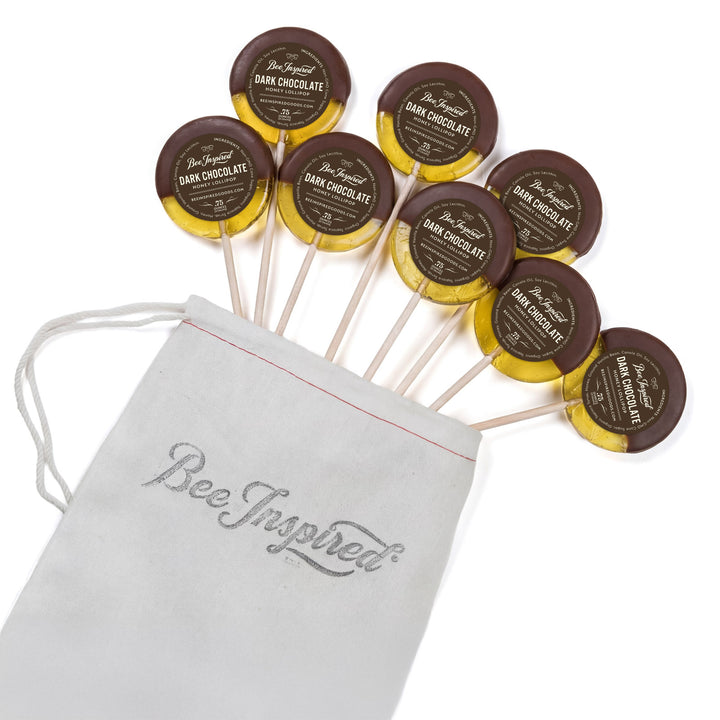 Dark chocolate lollipops with 'Bee Inspired' packaging on a white background