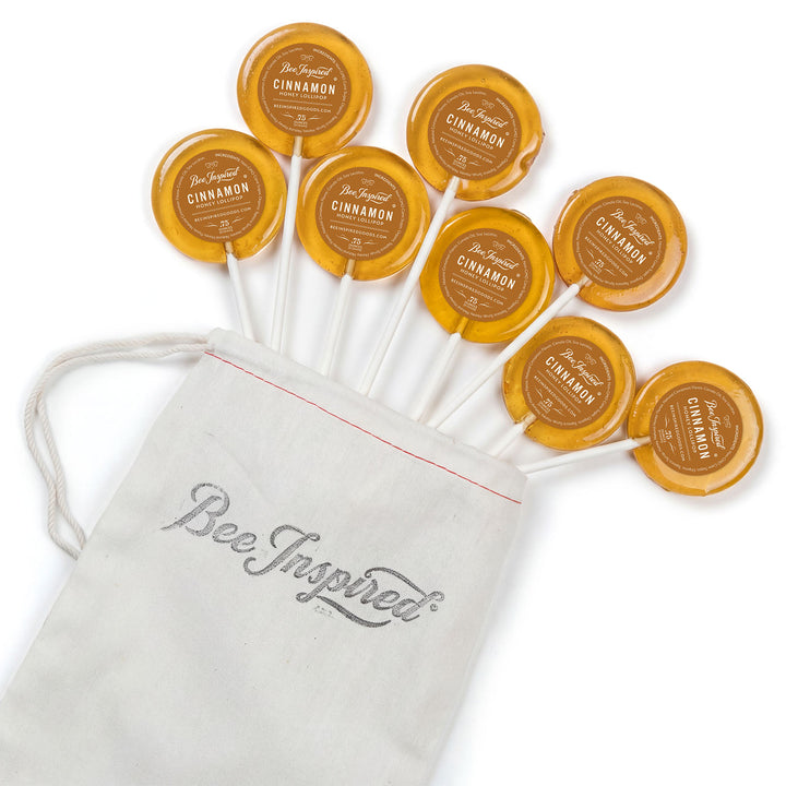 Bee Inspired cinnamon lollipops with a matching drawstring bag on a white background