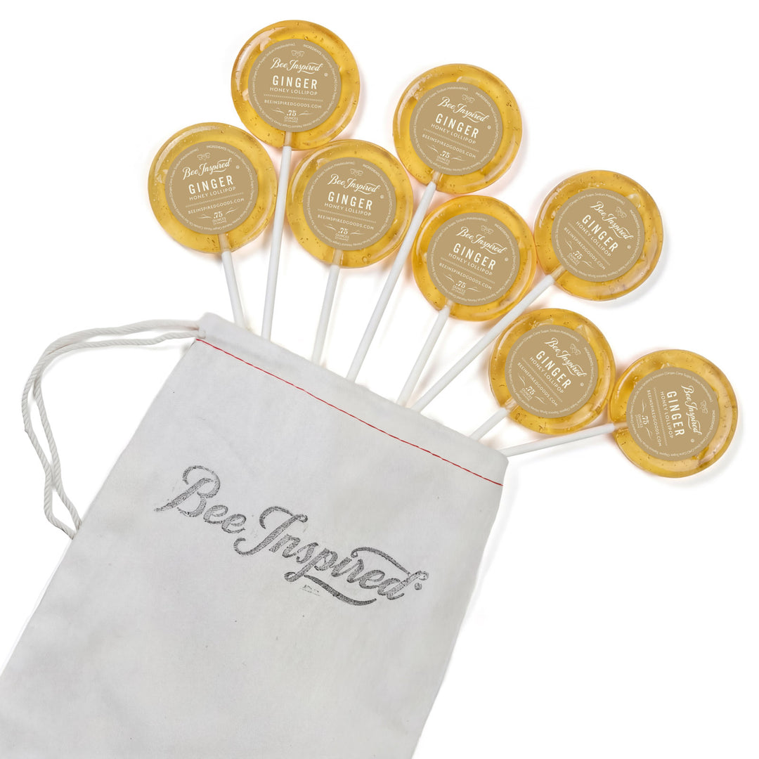 Yellow lollipops with 'Bee Inspired' text on a white background