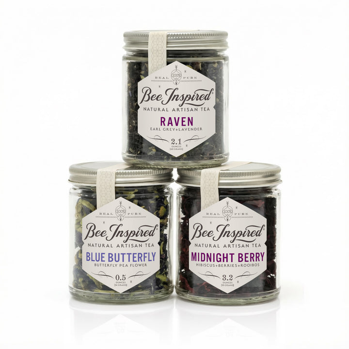 Three jars of 'Bee Inspired' natural artisan tea with labels on a white background
