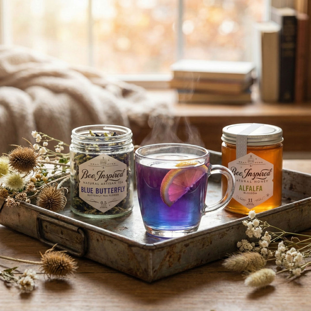 Tray with jars labeled 'Bee Inspired' and a glass of purple liquid on a wooden surface.