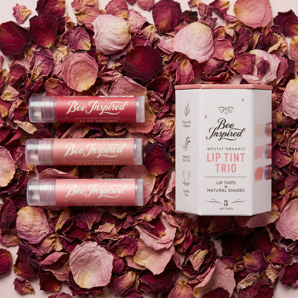 Bee Inspired lip tint products on a bed of dried rose petals