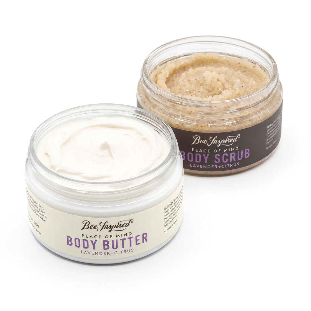 Two jars of 'Bee Inspired' body butter and body scrub on a white background