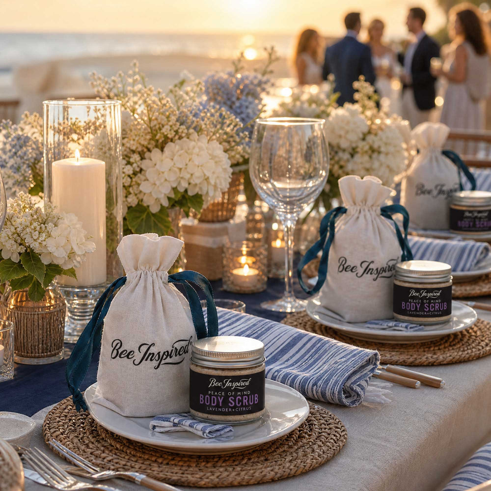 Table setting with 'Bee Inspired'  party favors in a beachside setting and people in the background