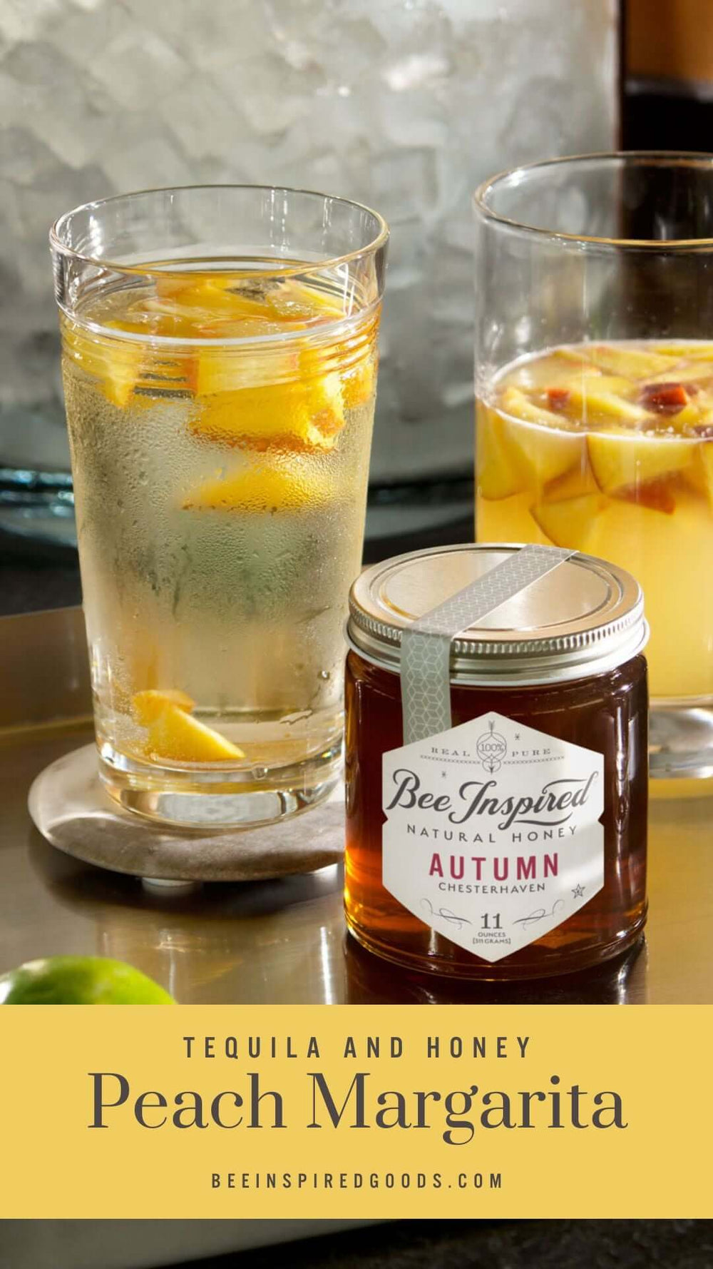 two glasses filled with peaches and peach margaritas behind Bee Inspired Autumn Honey from bee inspired honey retail store in owings mills with the text "Tequila and Honey Peach Margarita beeinspiredgoods.com"