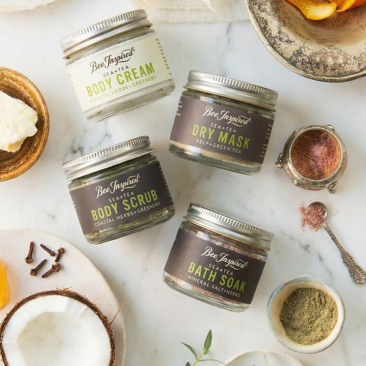 Collection of Bee Inspired skincare products on a marble surface with natural ingredients.