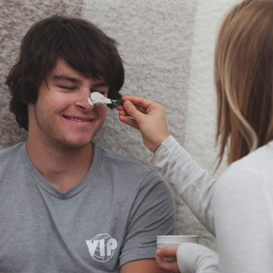 emily putting calming mask on kevin's face