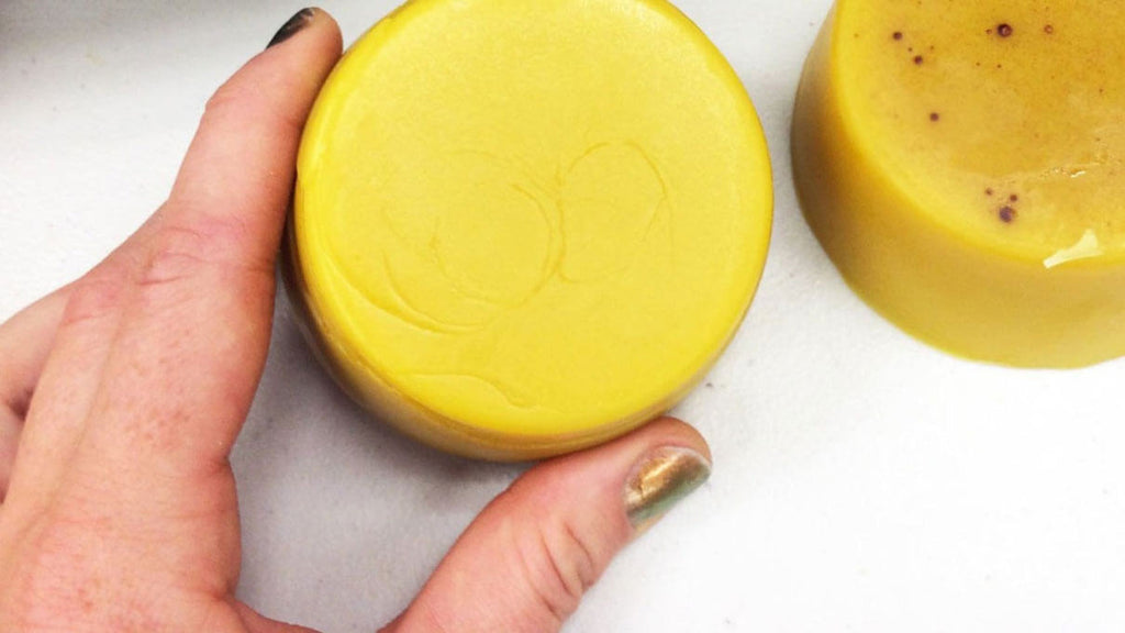 Person holds a piece of processed beeswax