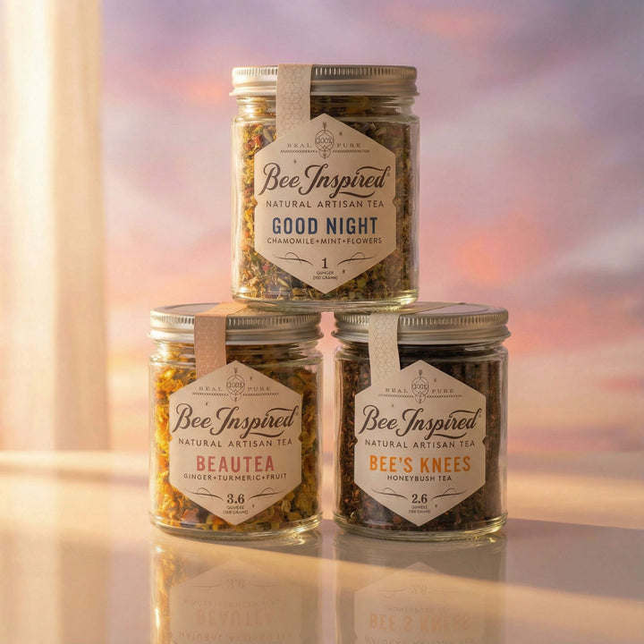 Jars of 'Bee Inspired' honey with floral decorations on a blurred natural background