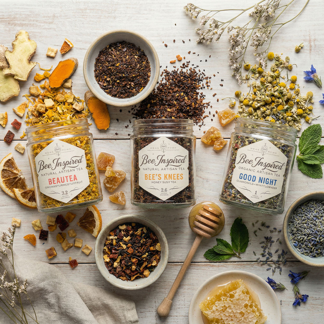 Assorted herbal teas and ingredients on a wooden surface with 'Bee Inspired' branding.
